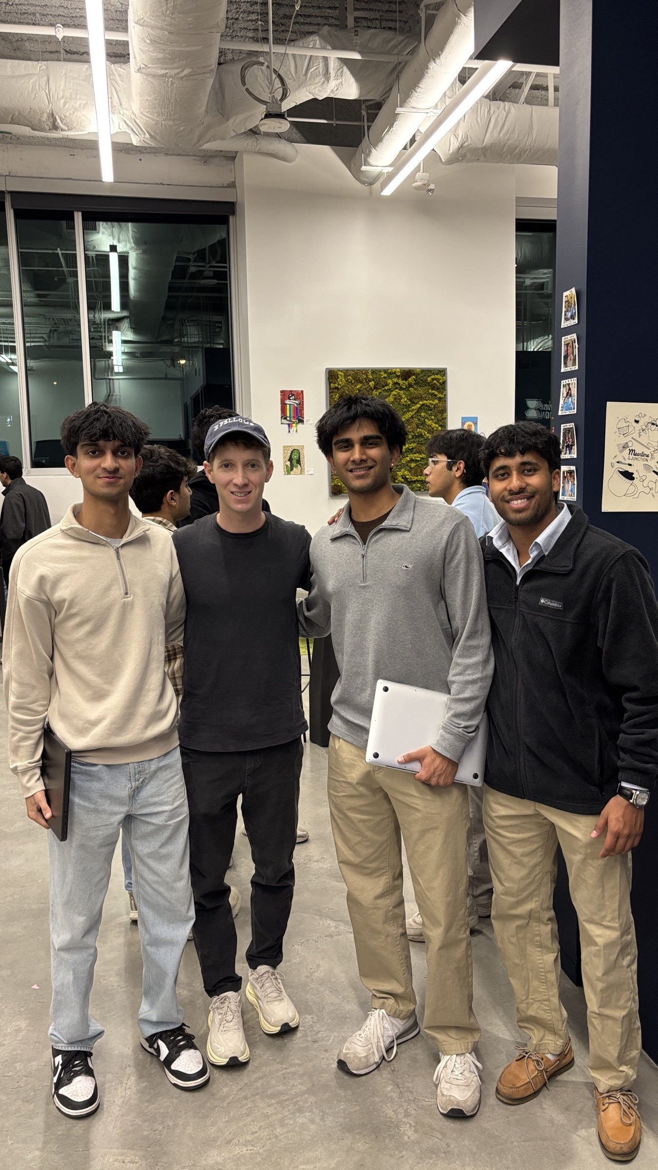 Jason with Cory Levy and two others at an indoor event.
